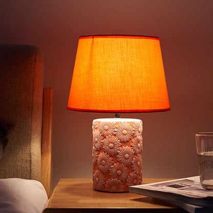 GloeiLieke - Orange tapered table lamp with carved sunflower base